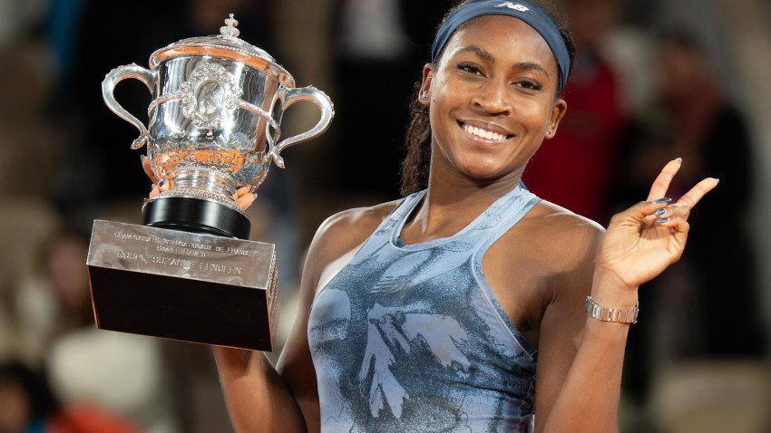 Coco Gauff holds a trophy