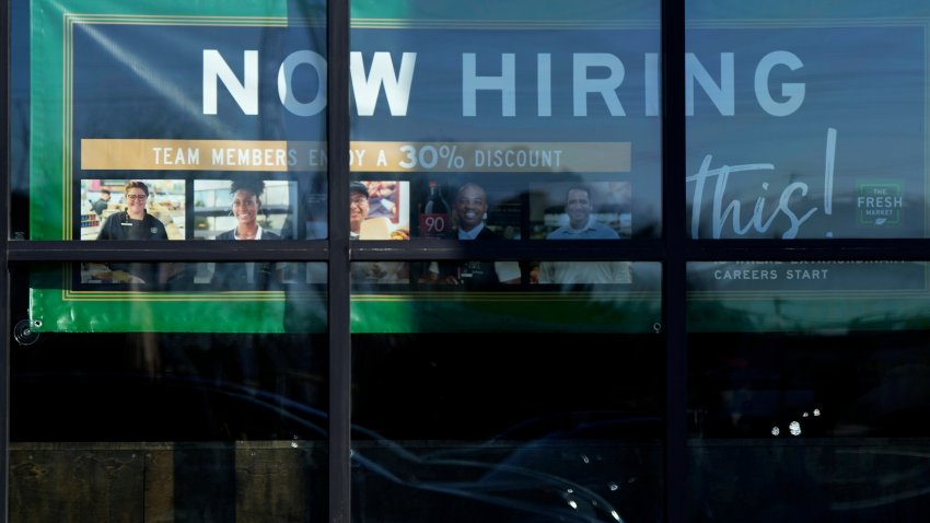 FILE – A hiring sign is displayed at a grocery store in Northbrook, Ill., Tuesday, Jan. 21, 2025. (AP Photo/Nam Y. Huh)