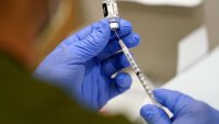 FILE – A healthcare worker fills a syringe with the Pfizer COVID-19 vaccine at Jackson Memorial Hospital on Oct. 5, 2021, in Miami.