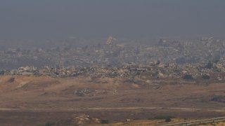 Destroyed buildings in the Gaza Strip are seen from southern Israel, Sunday, June 1, 2025. (AP Photo/Ohad Zwigenberg)