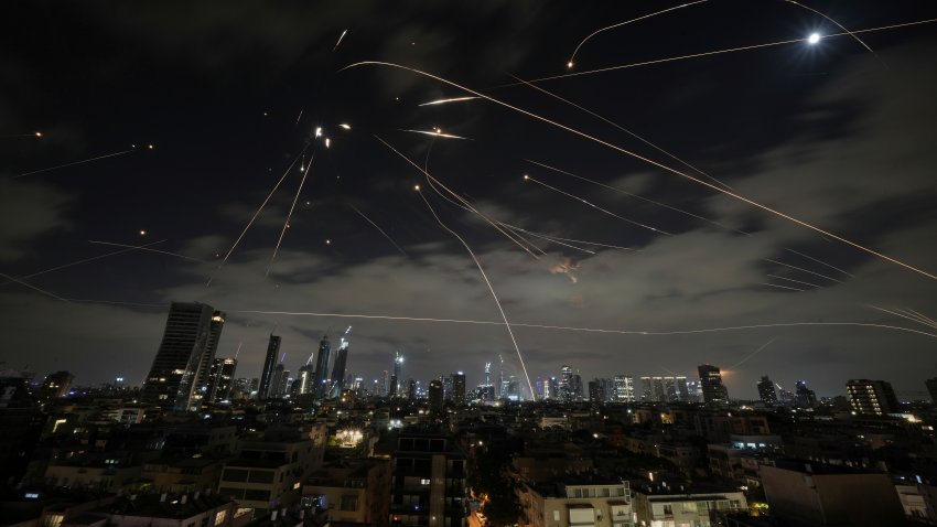 The Israeli Iron Dome air defense system fires to intercept missiles during an Iranian attack over Tel Aviv, Israel, Sunday, June 15, 2025.