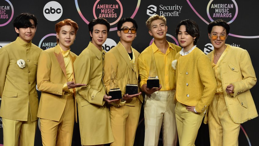 FILE – BTS poses in the press room with the awards for favorite pop duo or group, favorite pop song for “Butter,” and artist of the year at the American Music Awards on Sunday, Nov. 21, 2021, at Microsoft Theater in Los Angeles. (Photo by Jordan Strauss/Invision/AP, File)