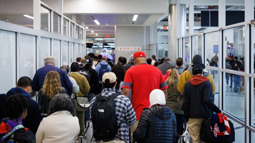 Travelers stand in line for security screening at Hartsfield-Jackson Atlanta International Airport