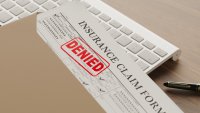 denied health insurance form on the table