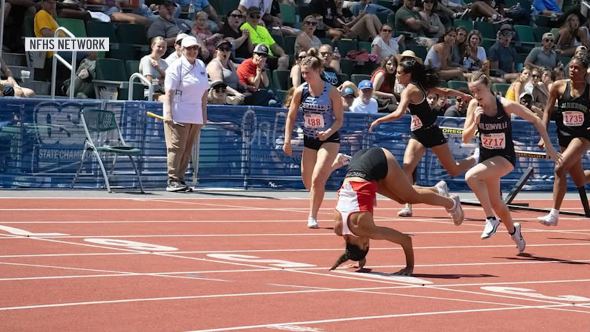 High school junior Brooklyn Anderson somersaults across finish line at track and field event