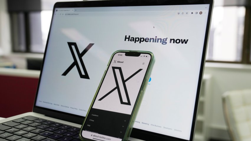 FILE - The opening page of X is displayed on a computer and phone in Sydney on Oct. 16, 2023.