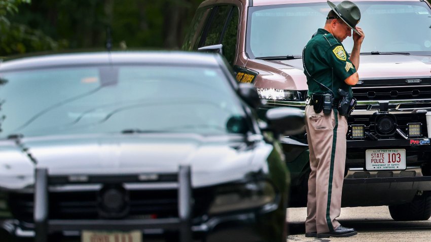 Madbury, NH – August 19: A New Hampshire State Trooper bows his head at the scene of an apparent murder suicide on Moharimet Drive on August 19, 2025. (Photo by Jonathan Wiggs/The Boston Globe via Getty Images)