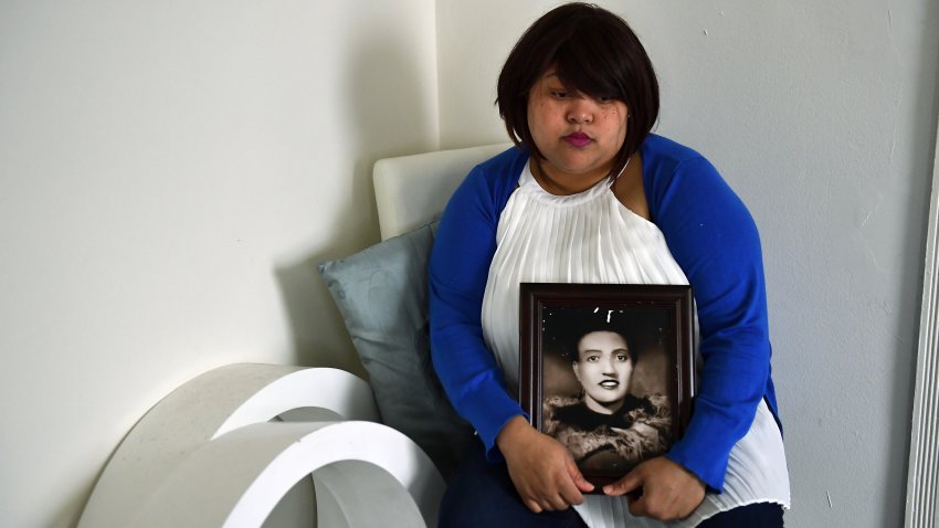 Veronica Spencer, great granddaughter of Henrietta Lacks, whose cancer cells are some of the most important in medical research, poses at her home with a portrait of her great grandmother March 28, 2017 in Baltimore.