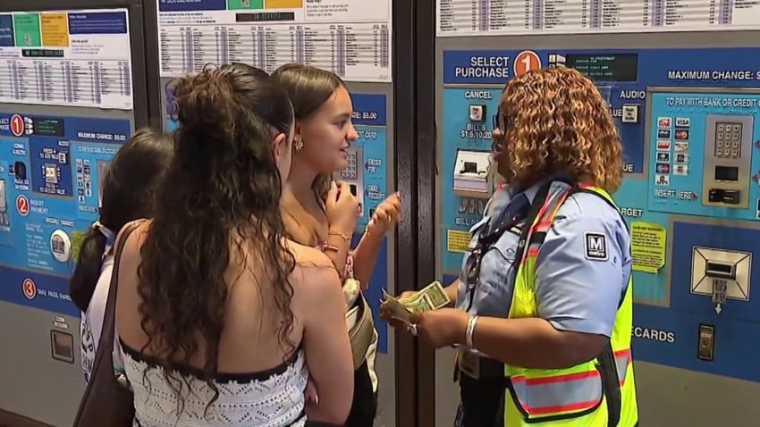 East Falls Church Metro station manager assists riders at the fare machines.