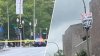 Protester scales DC light pole to hang anti-Xi banner before state visit