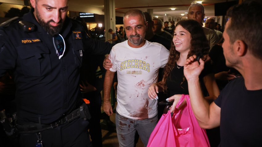 Israeli passenger Yaniv Hayoun, with blood stains on his shirt, who was aboard a Flydubai aircraft that made an emergency landing in Saudi Arabia, is welcomed at the arrivals gate at Ben Gurion International Airport near Tel Aviv, Israel, Wednesday, Sept. 30, 2026.