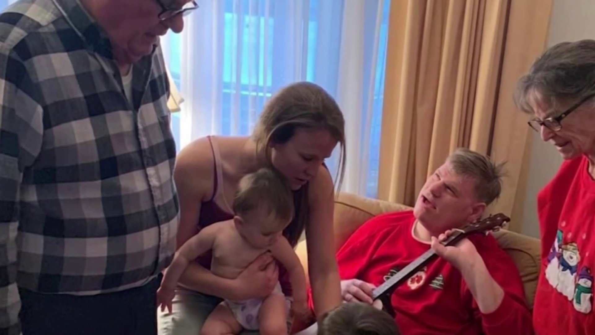 Erol Graeber plays guitar with family